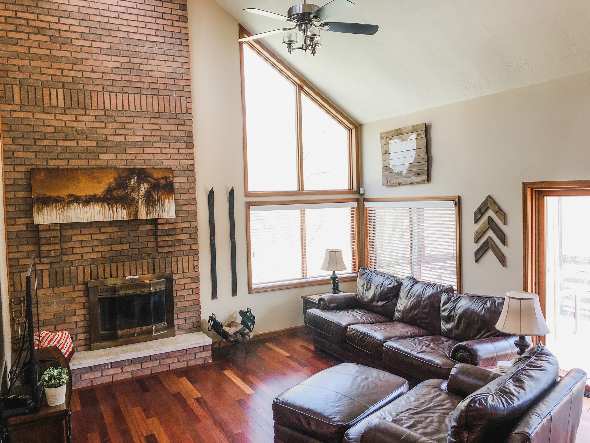 Living room with brick fireplace and vaulted ceiling at Cave and Creek
