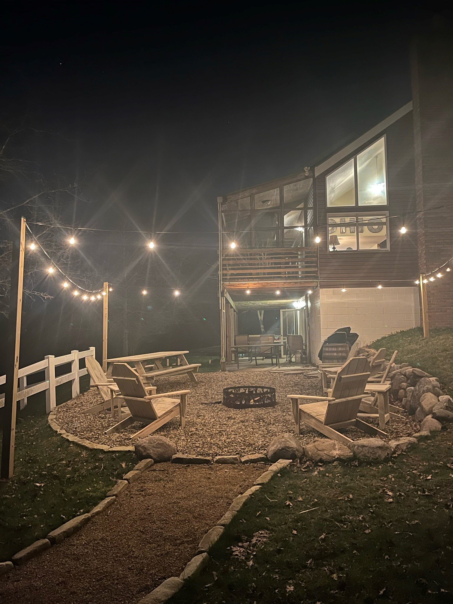 Cave and Creek fire pit area with string lights at night